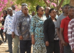 The ruling party CCM presidential candidate Dr. John Magufuli, third left, stands in line to cast his vote at Chamwino in Dodoma, Oct. 28, 2020.