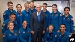 Vice President Mike Pence poses for a photograph with NASA's 12 new astronauts, June 7, 2017, at NASA's Johnson Space Center in Houston, Texas. They are, clockwise from top left, Robb Kulin, Jonny Kim, Bob Hines, Warren Hoburg, Matthew Dominick, Kayla Barron, Jessica Watkins, Raji Chari, Zena Cardman, Jasmin Moghbeli, Loral O' Hara and Frank Rubio. 