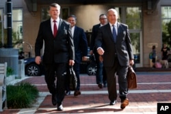 The defense team for Paul Manafort, including, Kevin Downing (L), and Thomas Zehnle (R) arrive at the Albert V. Bryan United States Courthouse for the trial of former Trump campaign chairman, Aug. 10, 2018, in Alexandria, Va.