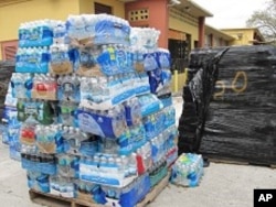 Palettes of bottled water destined for Haiti are neatly placed in Notre Dame d'Haiti church's parking lot, 3 Mar 2010