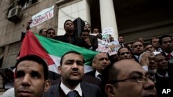 FILE - Lawyers hold a Palestinian flag during a protest after a U.S. decision to recognize Jerusalem as the capital of Israel, at the Lawyers Syndicate in Cairo, Egypt, Dec. 10, 2017.