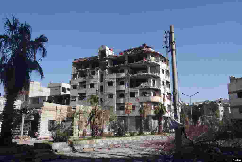 Buildings in Erbeen, near Damascus, damaged by missiles fired by a Syrian Air Force fighter jet, January 15, 2013. 