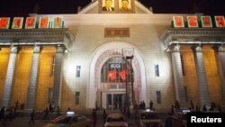 North Korea's state-directed economy is stagnant, but thriving grey-market entrepreneurship is driving increased spending on consumer goods and services like restaurants and taxis, like these parked outside a train station in Pyongyang, Oct. 7, 2015. 