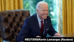 USA, Washington, U.S. President Joe Biden smiles after signing executive orders strengthening access to affordable healthcare