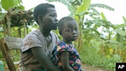 Pascazia Mukamana, of southwestern Rwanda, quit school to raise her three siblings after their mother died from AIDS. (File photo from May 6, 2003)