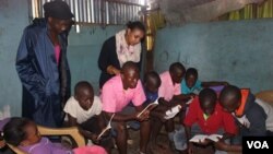 Betty Mutua, founder of Sauti ya Vitabu, looks on as children read books at one of the organization's pop-up centers. (R. Ombuor/VOA)