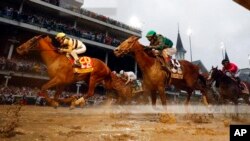 Flavien Prat rides Country House, left, to victory in the 145th running of the Kentucky Derby horse race, May 4, 2019, in Louisville, Ky. Code of Honor, right, finished second. Luis Saez on Maximum Security finished first but was disqualified.