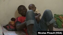 FILE - An ex-Boko Haram fighter play with a child in the transitional camp for ex-Boko Haram fighters in Diffa, Niger, April 17, 2017. (Nicolas Pinault/VOA)