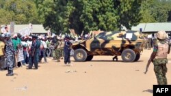 Soldiers and security block a road as they secure the venue during a rally of the ruling People's Democratic Party in Maiduguri, Nigeria, Jan. 24, 2015. 