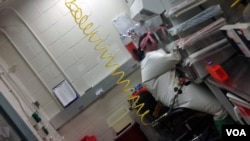 USAMRIID scientist Ana Kuhene works with samples of Ebola in a specially equipped lab at Fort Detrick in Maryland, where the most deadly pathogens are handled on Dec. 11, 2014. (VOA/C.Maddux)