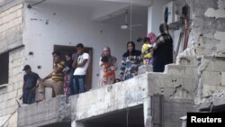 Residents inspect damage after shelling that activists attribute to forces loyal to Syrian President Bashar al-Assad, Raqqa province, May 2, 2013.