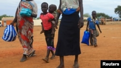 FILE - A South Sudan refugee family arrives at a refugee reception point at Elegu, within Amuru district of the northern region near the South Sudan-Uganda border, Aug. 20, 2016.