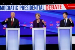 Democratic presidential candidate former Vice President Joe Biden, left, Sen. Elizabeth Warren, D-Mass., center and South Bend Mayor Pete Buttigieg speak during a Democratic presidential primary debate hosted by CNN/New York Times at Otterbein…