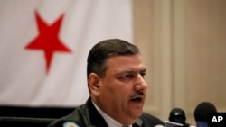 Riad Hijab, Syria’s defected former prime minister, speaks at a press conference at the Hyatt Hotel in Amman, Jordan, August 14, 2012.