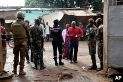 FILE - Security officers stand guard in front of a polling station during presidential elections, in Bamako, Mali, July 29, 2018.