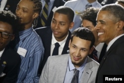 U.S. President Barack Obama, right, poses with students at New York's Lehman College after announcing the launch of My Brother's Keeper Alliance, May 4, 2015.