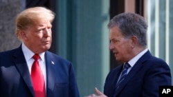 FILE - In this July 16, 2018 photo, U.S. President Donald Trump, left, talks with Finnish President Sauli Niinisto as they pose for a photo in Helsinki, Finland. 