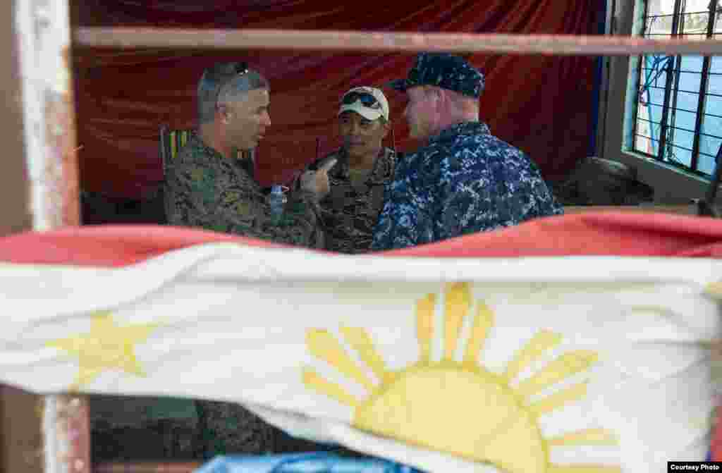 From left to right: U.S. Marine Corps Brig. Gen. Paul Kennedy, commanding general, 3d Marine Expeditionary Brigade; Philippine navy Capt. Roy Vincent Trinidad, officer in charge, Tacloban airfield; and U.S. Navy Rear Adm. Mark Montgomery, commander, Battl
