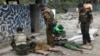 Soldiers stand near two dead bodies at Gote Twin police outpost after an attack in Gote Twin, Naung Cho township, northern Shan State, Myanmar, Aug. 15, 2019. 