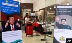 Signs depicting U.S. President Donald Trump and North Korean leader Kim Jong Un are displayed in a barbershop in Hanoi, Vietnam, Feb. 19, 2019. The two leaders have become style icons ahead of their upcoming summit in Hanoi.