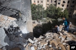 Palestinians inspect the damage of a destroyed house following a late night Israeli missile strike in town of Beit Lahiya, Northern Gaza Strip, May. 6, 2019.