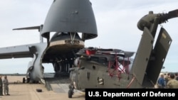 Soldiers prepare to load a Blackhawk helicopter into a C-5M Super Galaxy, Sept. 11, 2017. The helicopter is one of 35 aircraft relocating in preparation to support Hurricane Irma relief efforts.