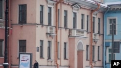 FILE - In this photo taken on Feb. 18, 2018, a security guard walks outside the Concord Catering office in St. Petersburg, Russia.