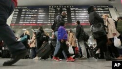 Amtrak passengers walk to their gates in New York's Pennsylvania Station, Nov. 25, 2015.