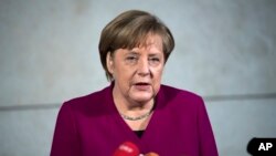 FILE - German chancellor Angela Merkel delivers a statement in Berlin, Jan. 7, 2018. 