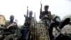 FILE - Child soldiers of the Seleka coalition sits on a pickup truck near the Presidential palace in Bangui, March 25, 2013. 