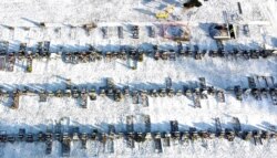 A worker digs a grave in a cemetery amid the coronavirus disease (COVID-19) outbreak in Manchester, Britain, Jan. 25, 2021. Picture taken with a drone.
