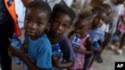Children line up for food at a shelter for families displaced by gang violence in the Tabarre neighborhood of Port-au-Prince, Haiti, on May 19, 2024. UNICEF this week warned that violence, mass displacement, epidemics and malnutrition are breaking Haiti's health care system.