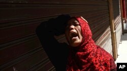 An Egyptian woman mourns after a judge sentenced to death 683 alleged supporters of the country's ousted Islamist president over acts of violence and the murder of policemen in the latest mass trial in the southern city of Minya, Egypt, April 28, 2014. 