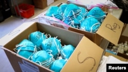 FILE - Boxes of N95 protective masks for use by medical field personnel are seen at a New York State emergency operations incident command center during the coronavirus outbreak in New Rochelle, New York, March 17, 2020.