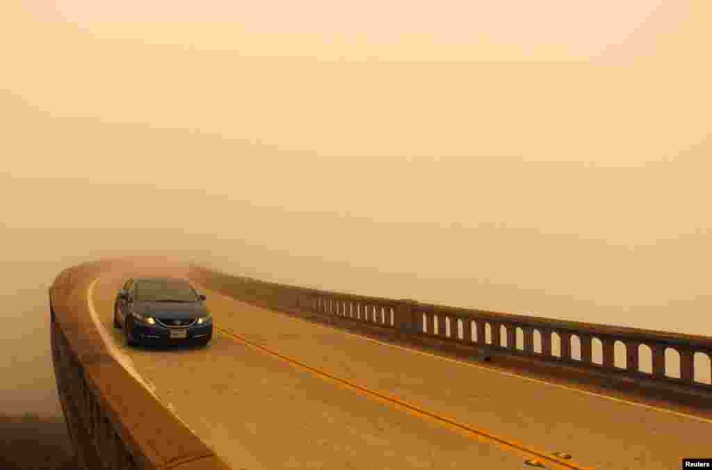 Smoke from the Soberanes Fire combined with a marine layer reduces visibility over Bixby Bridge on State Route 1 north of Big Sur, California, July 26, 2016.