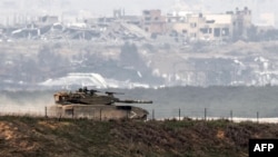 An Israeli battle tank moves along the border with the Gaza Strip and southern Israel on Dec. 27, 2023 amid continuing battles between Israel and the militant group Hamas.