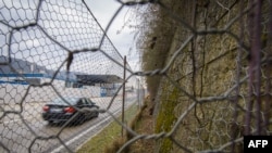 FILE - A border crossing and a fence are seen in in the village of Spielfeld, Austria, at the Austria-Slovenia border, Feb. 21, 2017. 