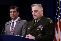 FILE - Defense Secretary Mark Esper, left, and Chairman of the Joint Chiefs of Staff Army Gen. Mark Milley attend a briefing at the Pentagon in Washington, March 2, 2020.