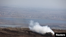 An Israeli tank maneuvers close to the ceasefire line between Israel and Syria on the Israeli-occupied Golan Heights, Nov. 13, 2012.