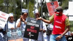 Kenya Corruption: Demonstrators wear mock prison outfits to show that they want to imprison those engaged in corruption, in Nairobi, Kenya, Nov. 3, 2016.