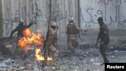 Iraqi security forces clash with demonstrators during anti-government protests in Baghdad, Iraq, Nov. 23, 2019. 