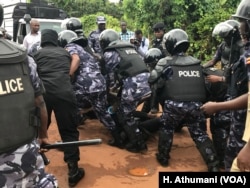 A male protester is arrested by Uganda police officers during a march against kidnappings and murders in Uganda, June 5, 2018.
