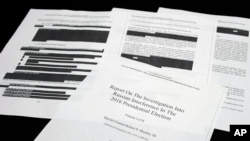 Four pages of the Mueller Report lay on a witness table in the House Intelligence Committee hearing room on Capitol Hill, April 18, 2019.
