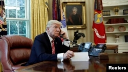 FILE - U.S. President Donald Trump is seen during a phone call at the Oval Office of the White House, in Washington, June 27, 2017.