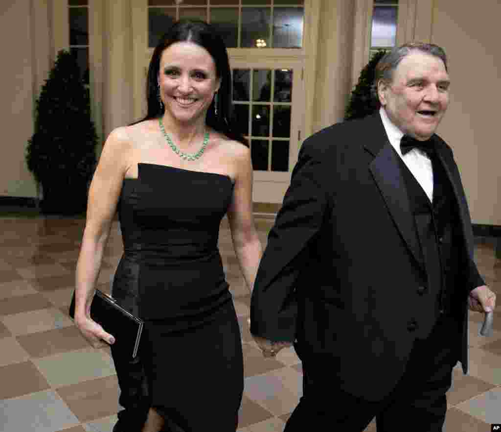 Actress Julia Louis-Dreyfus arrives for a State Dinner in honor of French President François Hollande, with her father William Louis-Dreyfus at the White House, Feb. 11, 2014.