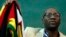 FILE - Zimbabwean Pastor Evan Mawarire holds his country's flag before addressing supporters at the University of the Witwatersrand in Johannesburg, South Africa, July 28, 2016.