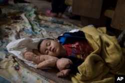 A Central American child who is traveling with a caravan of migrants sleeps at a shelter in Tijuana, Mexico, April 29, 2018.