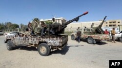 Forces loyal to Libya's Government of National Accord (GNA) celebrate on April 18, 2019, after taking control of al-Aziziyah, located some 40 kilometers south of the capital Tripoli, following fierce clashes with forces loyal to strongman Khalifa Haftar. 