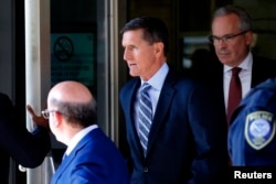 FILE - Former U.S. National Security Adviser Michael Flynn departs U.S. District Court, where pleaded guilty to lying to the FBI about his contacts with Russia's ambassador to the United States, in Washington, Dec. 1, 2017.