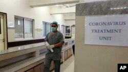 FILE - A Pakistani doctor enters an isolation ward set up as a preventive measure following the deadly coronavirus outbreak, at the Jinnah Postgraduate Medical Centre in Karachi, Pakistan, Feb. 3, 2020.